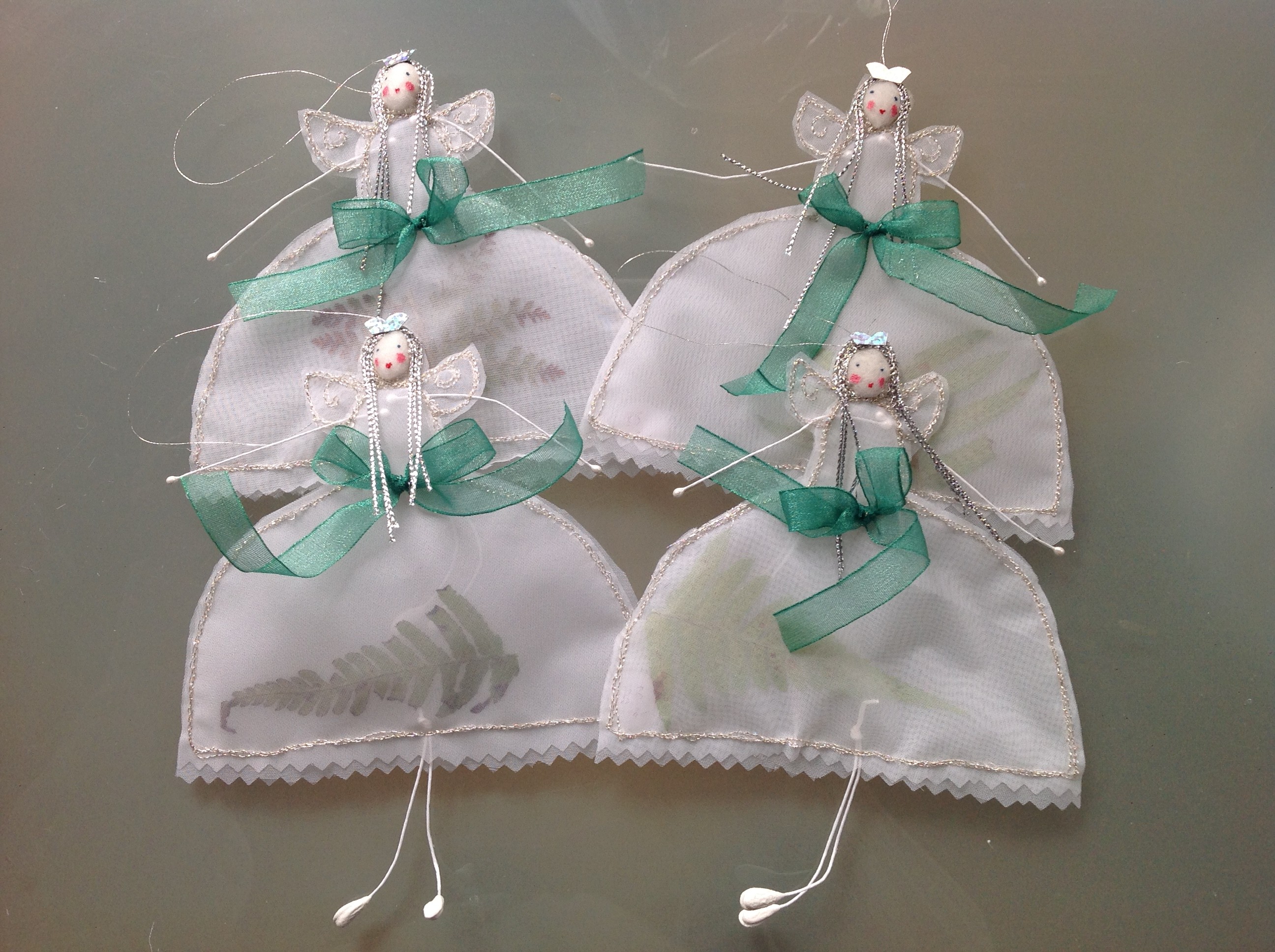 14cm high transparent stiff white organdie fairies with fern/evergreen dried leaves inserted. £9.50 including postage.