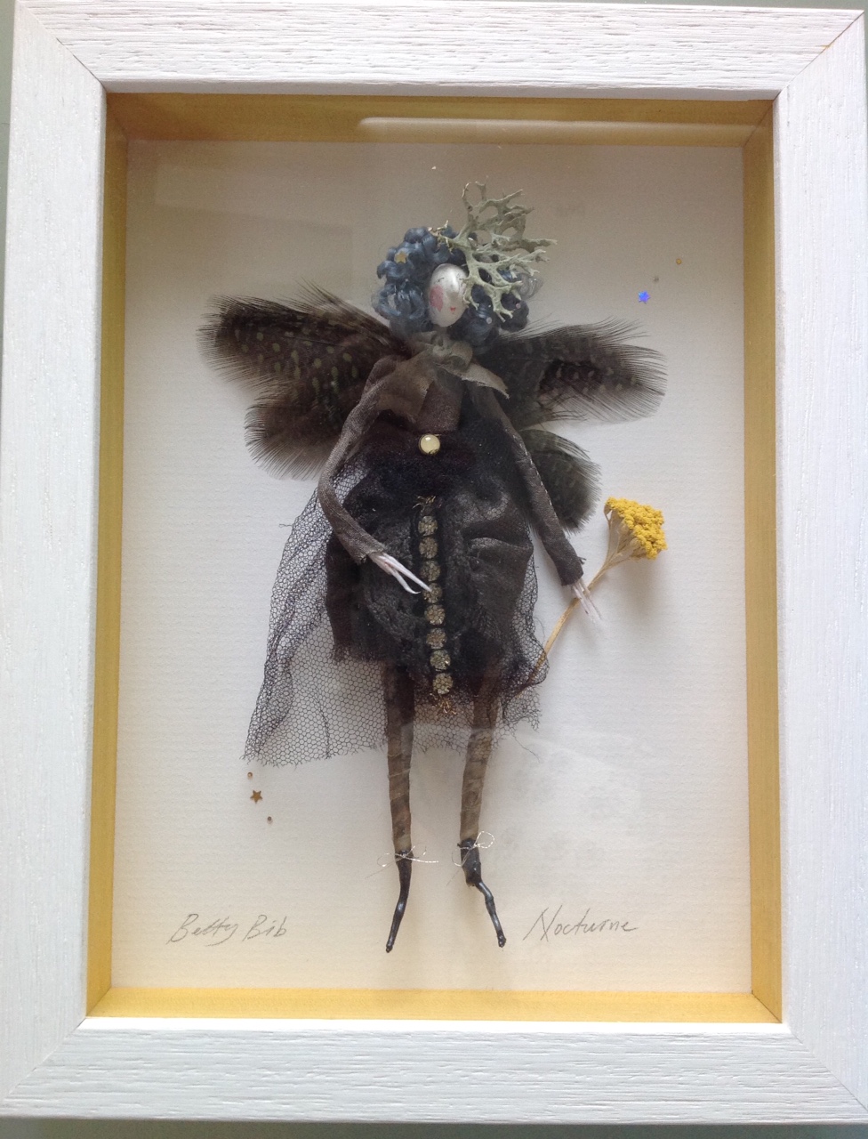 NOCTURNE ; a 23x17.5 cm boxed fairy. She is wearing hand dyed clothes ( alder cones ) trimmed with vintage diamante, has a dried lichen hat and dyed guinea feather wings. She is holding a piece of dried yarrow. £95 plus £3.50 postage. Please e mail me if you would like to see her in more detail.
