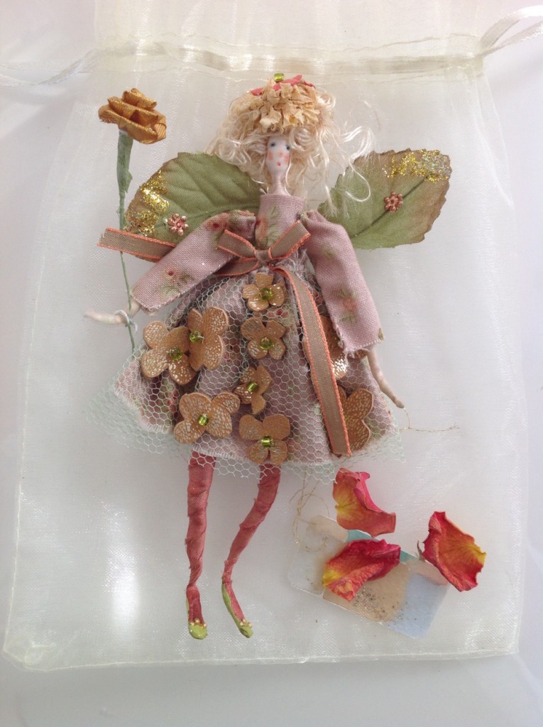 ROSEBUD; A 14cm high fairy dressed in cotton, net and embellished with soft gold leather flowers and beads. She comes with a hand painted name tag and in an organza bag with dried petals. £25 plus £2 p&p