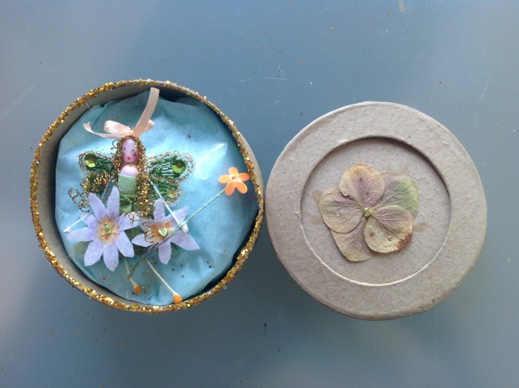 A 7cm round boxed fairy embroidered with hand- painted daisies, sequins and a fine silk ribbon. her name is in the lid which has a pressed hydrangea flower . £11.50 plus £3.50 P&P.