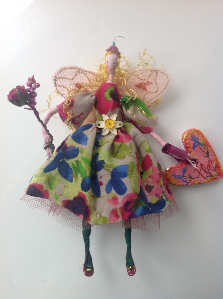 FLORA A 14cm Lonely Heart fairy with a silk painted head. She is wearing a silk crepe dress with a vintage narcissus flower at her waist and stiff net underskirt ... her wings are embroidered organza and she is holding a paper flower bouquet and a painted clay name tag. £27 plus £2 p&p.