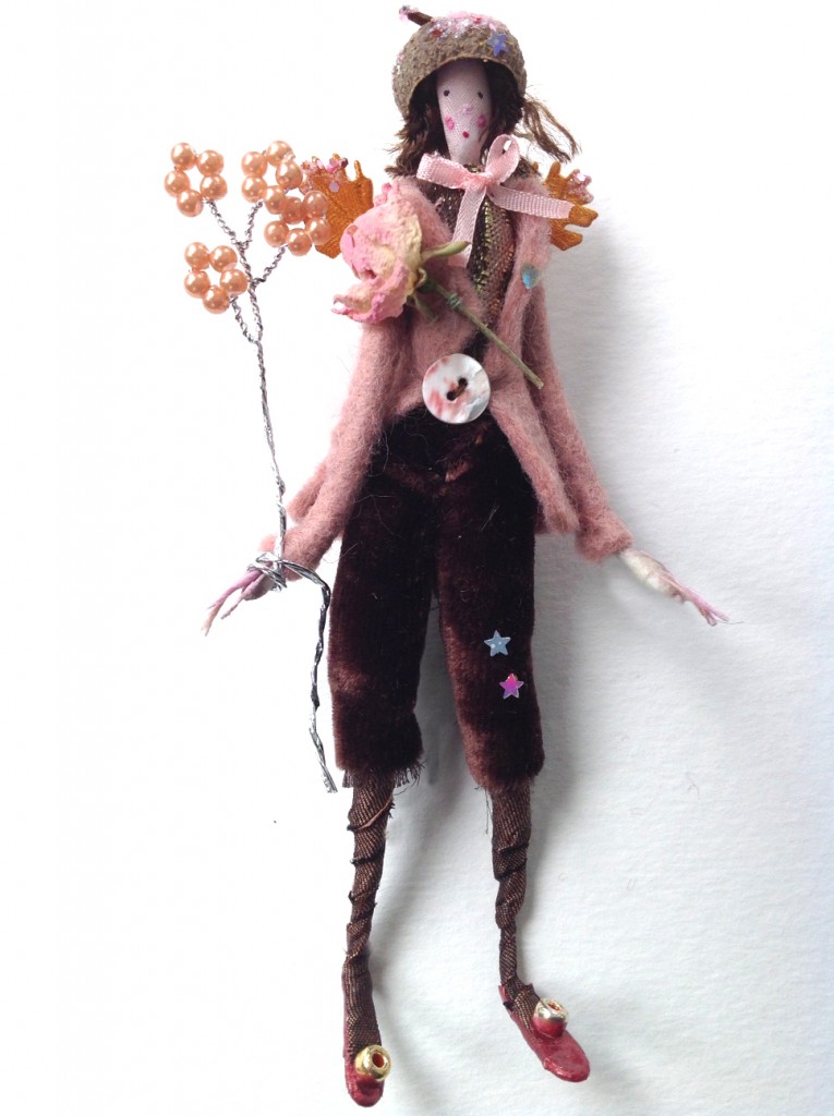 TEA-ROSE A 12cm high fairy wearing a felted coat with pearl button, silk velvet breeches and a brocade top . Tea-Rose has a dried rose buttonhole , tiny glittered wings, a pearl wand and a glittered acorn cup hat. She/he comes in a 15cm long box , decorated with dried flowers from my garden and is a numbered limited edition.( Number 1) £40 plus £3.50 postage