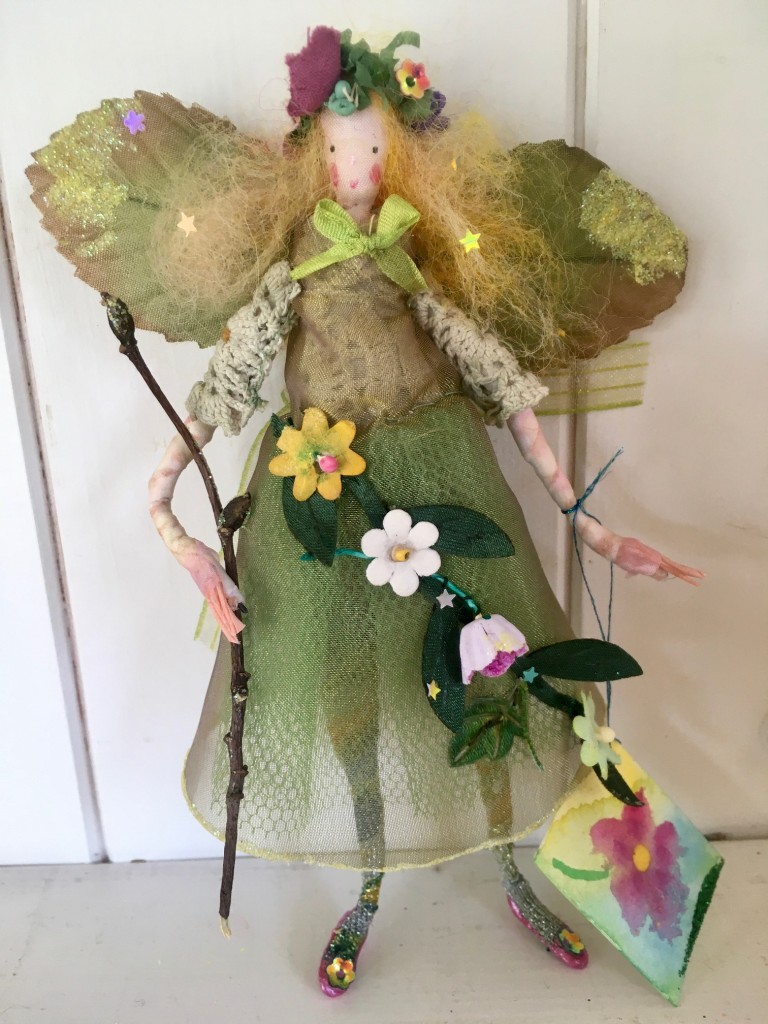 SWEET MAY A 13cm high fairy with a silk painted face. This little Spring fairy is wearing a vintage cotton crochet top overlaid with a shot organza dress with a glittered hem. She has a paper and fabric flower garland embellished with sequins , an organza bow at her back and is holding a glittered twig. She comes with a hand painted name tag and in an organza bag. £35 including UK postage.